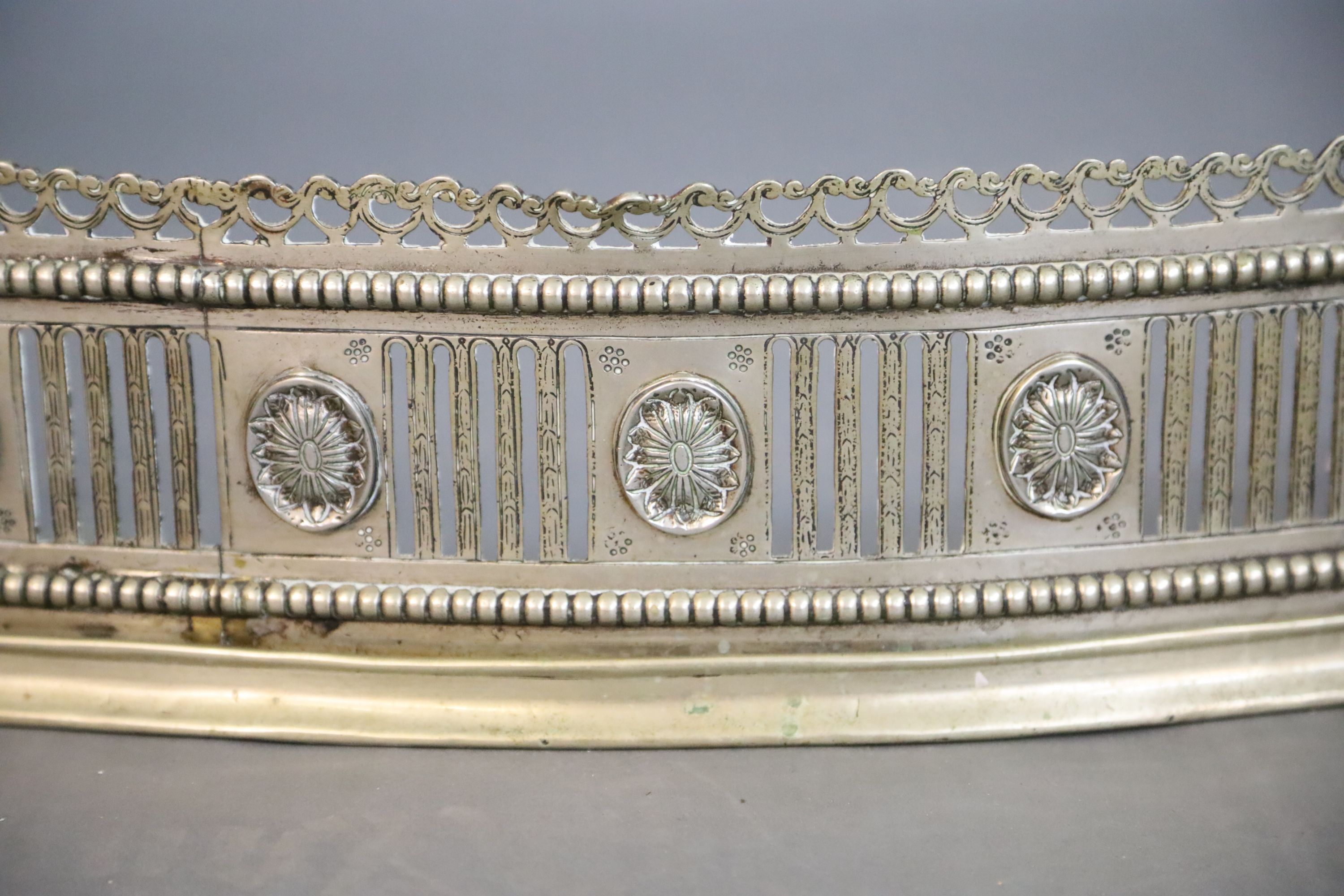 A George III bowed neo-classical fluted and pierced fender, W.145cm